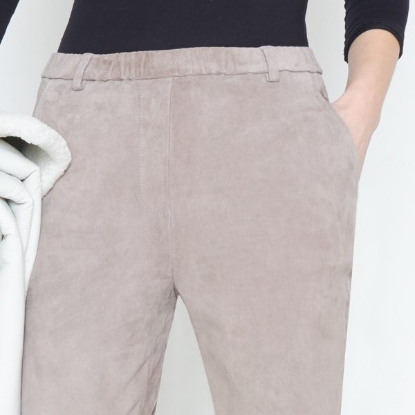 Waistband detail of gray velour leather trousers
