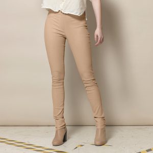 Woman in beige leather leggings